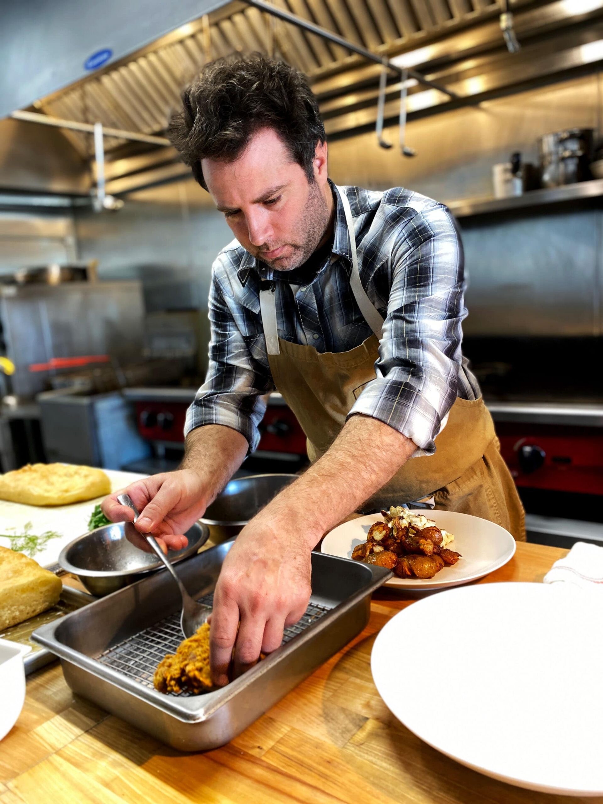 Chef Nathan Lemley cooking chicken fried steak in the Commerce Cafe kitchen in Lockhart, Texas.