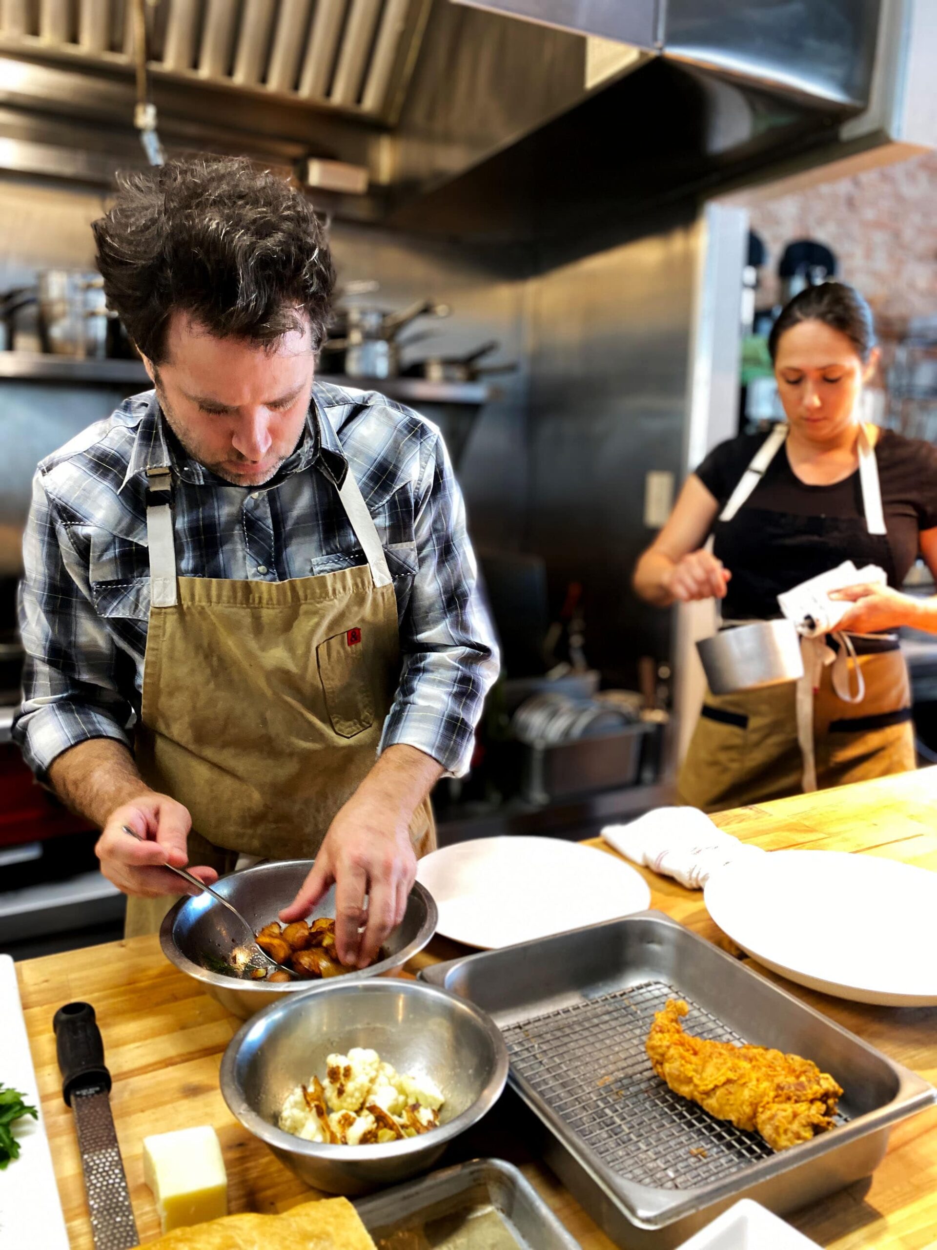 Chefs Nathan Lemley and Sarah Heard cooking together at Commerce Cafe in Lockhart, Texas.