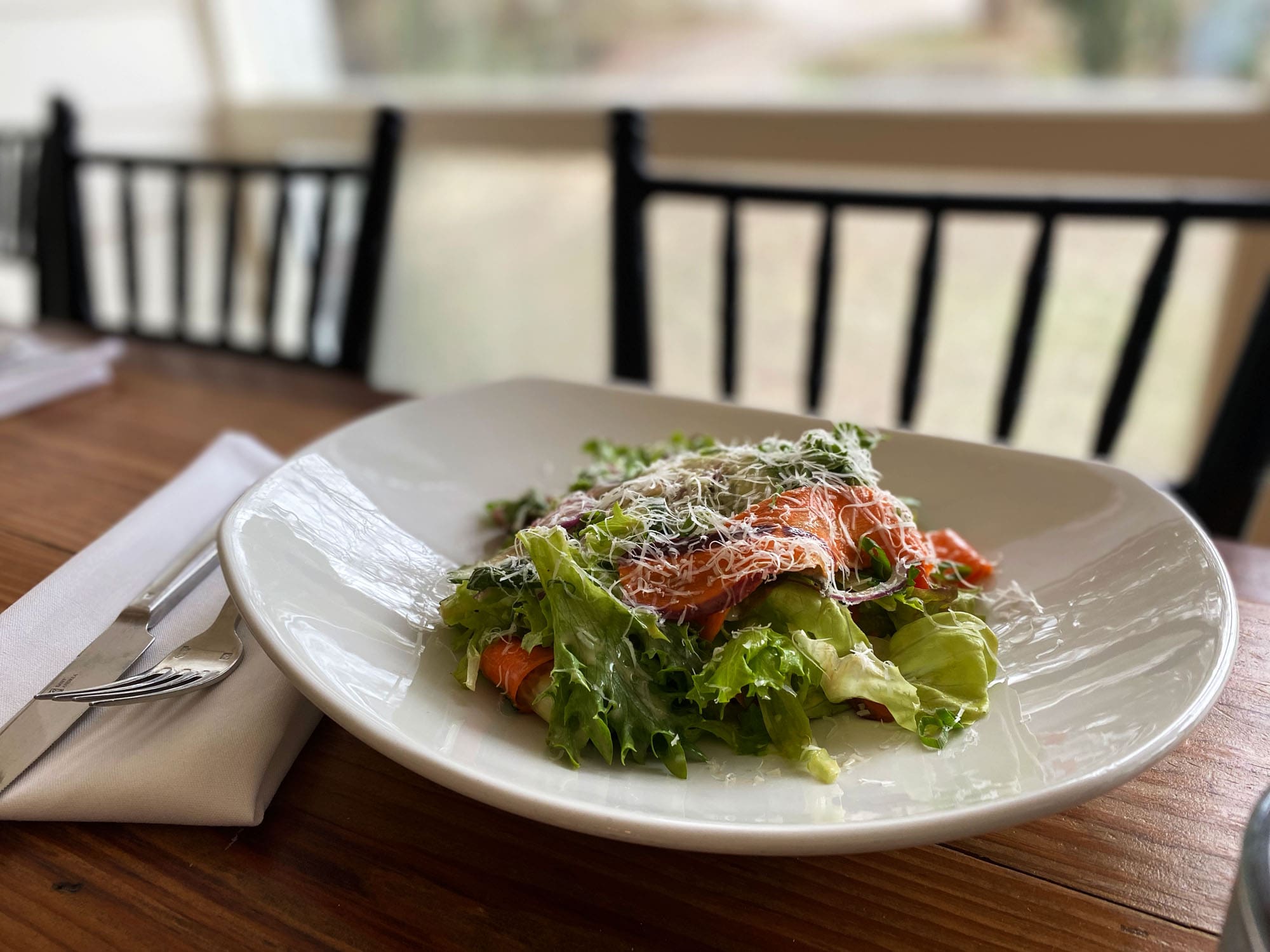 TrueHarvest butter lettuce salad in a white dish in Stagecoach restaurant in Salado, Texas.