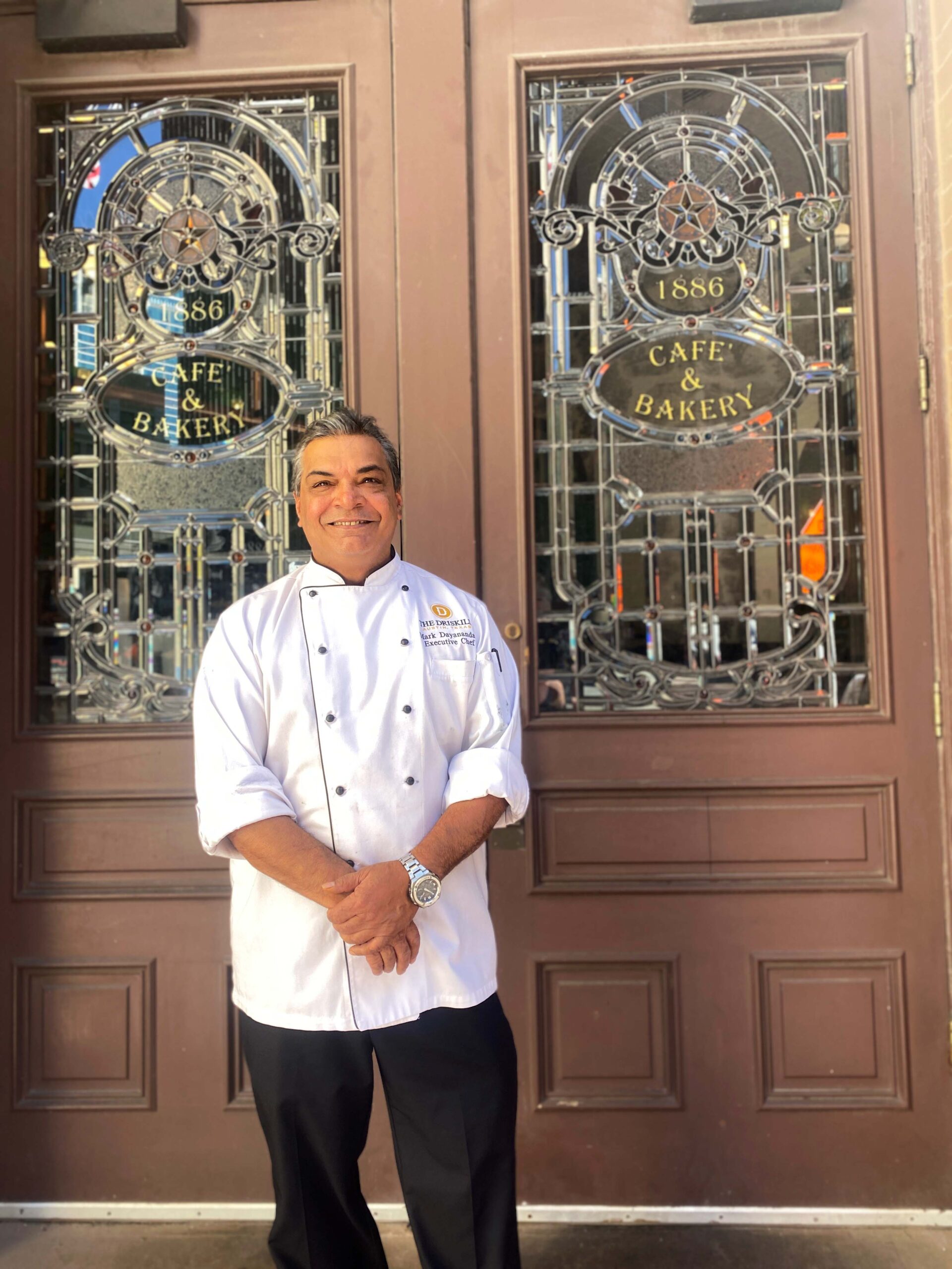 The Driskill Hotel Executive Chef Mark Dayanandan stands outside the 1886 Cafe and Bakery