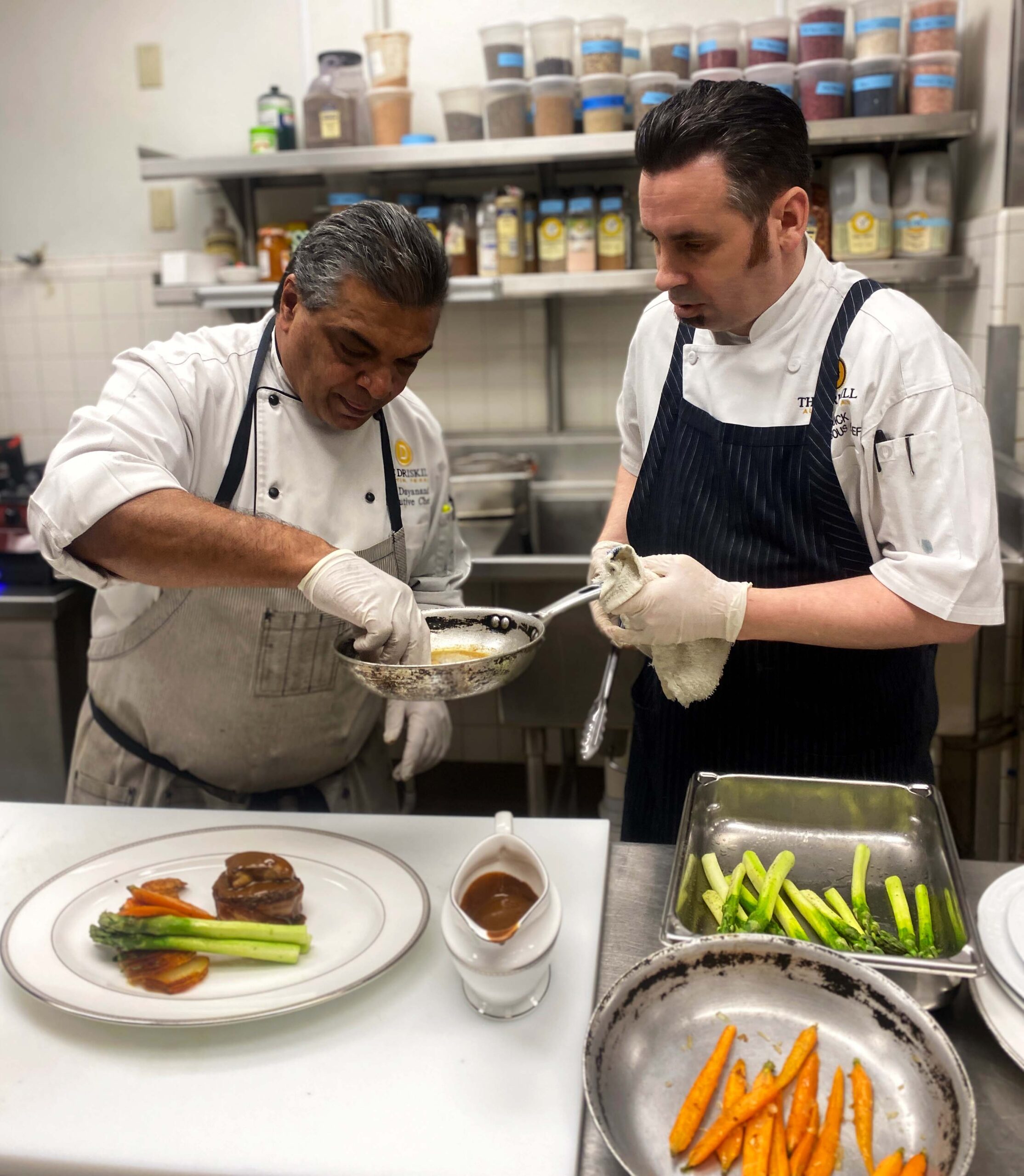 Chef Mark Dayanandan and Sous Chef Iain Reddick work together in the kitchen